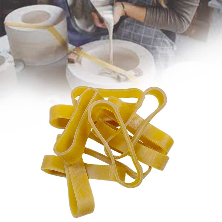 Yellow rubber bands in a pile, with a pottery-making background