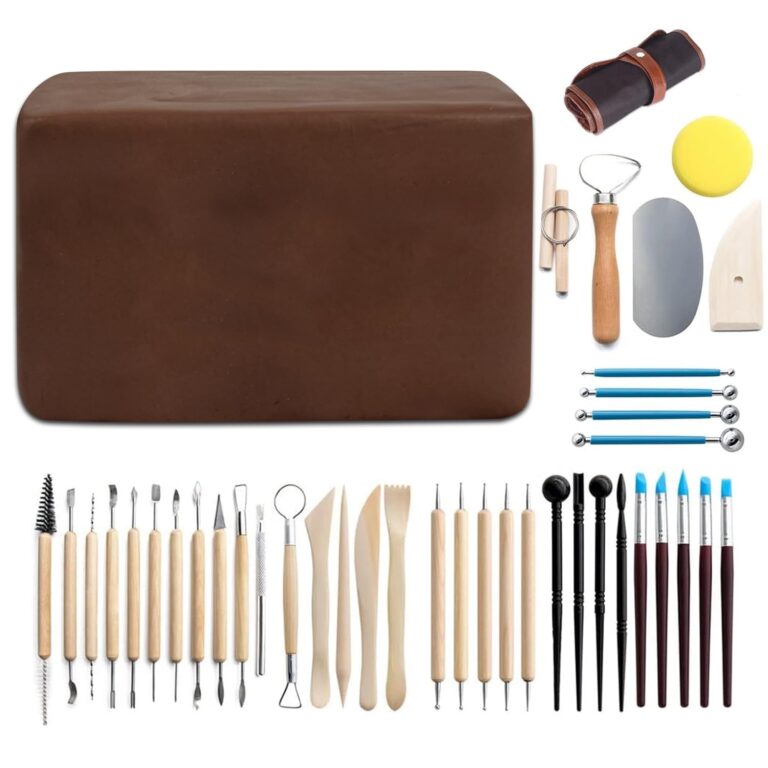 Brown clay block with sculpting tools and brushes for pottery