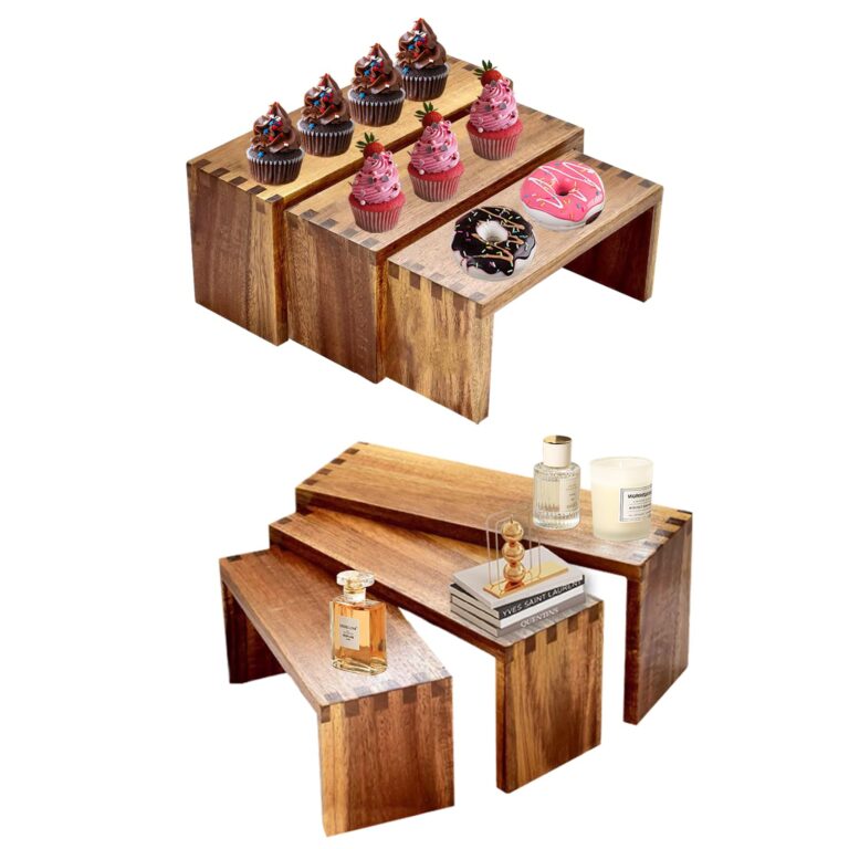 Cupcakes and donuts on wooden tiered stands, perfume and decor below