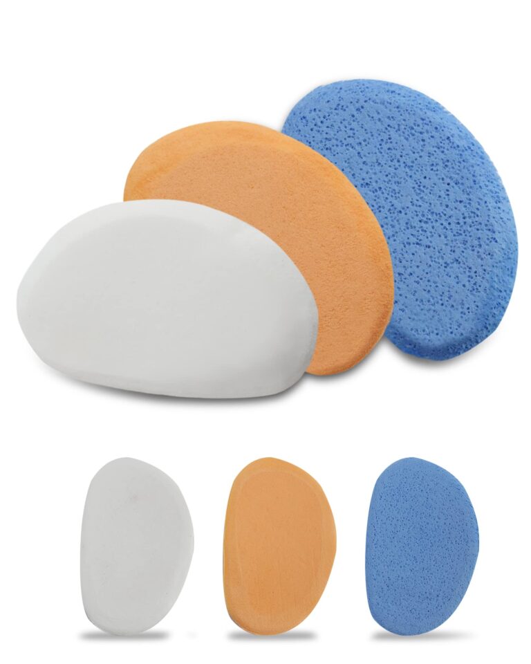 Three colorful facial sponges: white, orange, and blue, arranged in a row